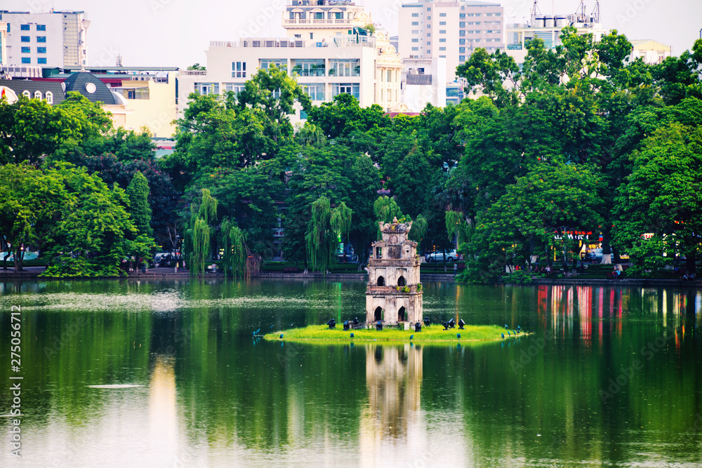 Turtle Tower at Hoan Kiem Lake in Hanoi, Vietnam. Tree at the foreground