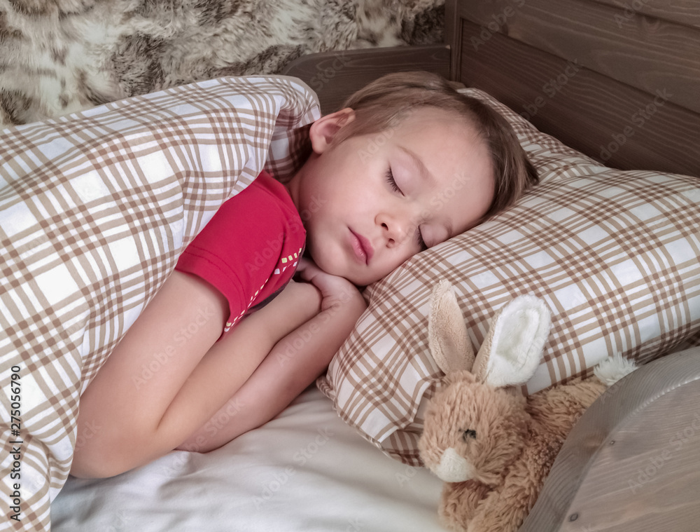 Cute little boy sleeping, tired child taking a nap in his small bed, clean, fresh and cozy bedding sheets, bedtime for kids Cute little boy sleeping, tired child taking a nap in his small bed, clean, fresh and cozy bedding sheets, bedtime for kids