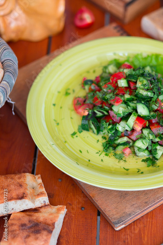 Vegetable green salad, choban salati in green plate. photo