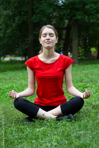 Girl practices yoga and meditates in the lotus position