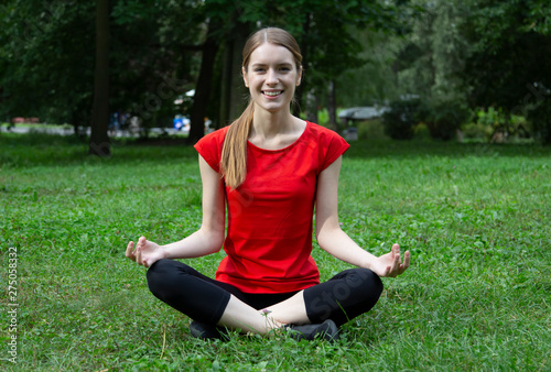 Girl practices yoga and meditates in the lotus position