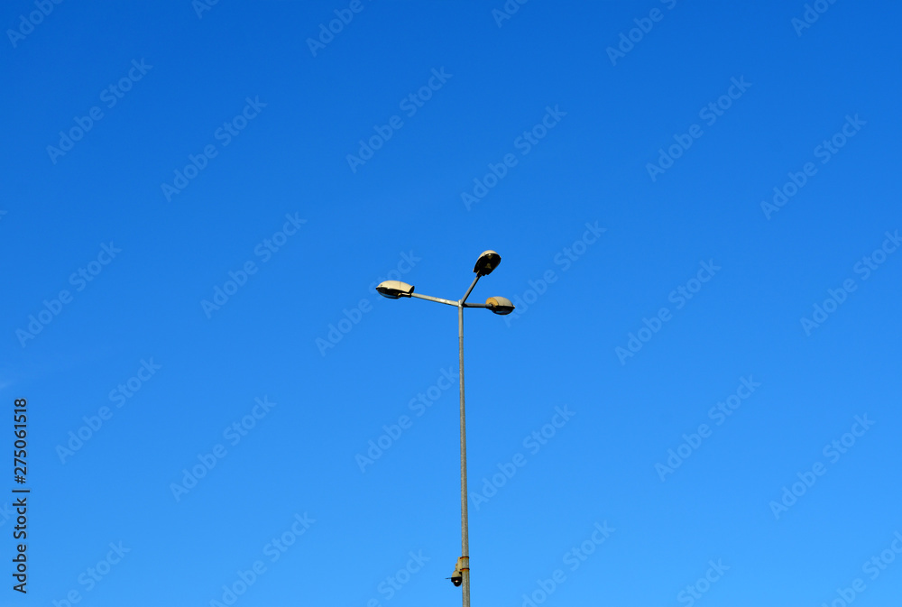 Street light with halogen lamp against blue sky Street light with halogen lamp against blue sky