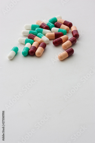 colorful pills on white background from above