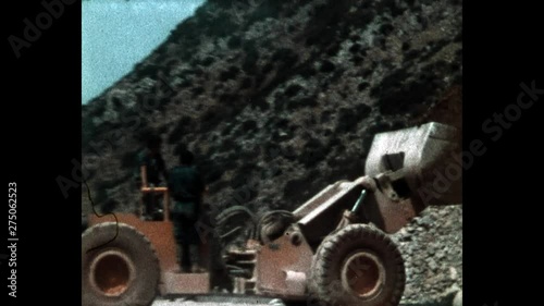 1970s, Italy: Miner working outside a mine with tractor