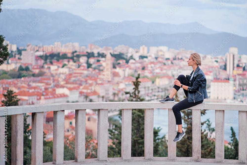 Travel by Croatia. Young traveling woman enjoying the view of Split city.