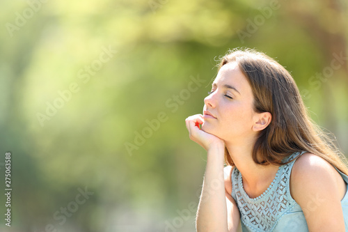 Serious woman meditating and relaxing in a forest