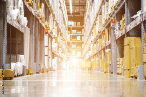 Huge distribution warehouse with high shelves and loaders, Rows of with boxes, Rows of shelves with boxes, Blurred business background, Blurred business background.