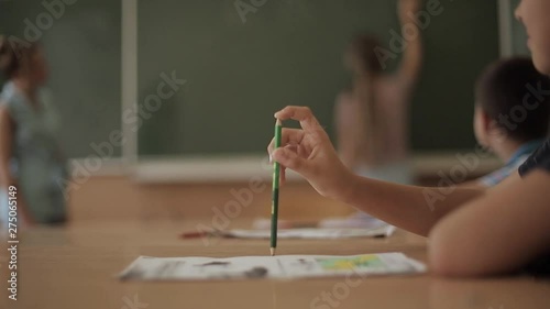 Schoolboy rise hand in classroom. Elementary school. Education