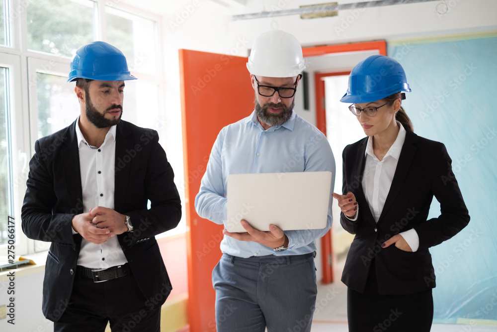 Engineers in hardhats have conversation Engineers in hardhats have conversation