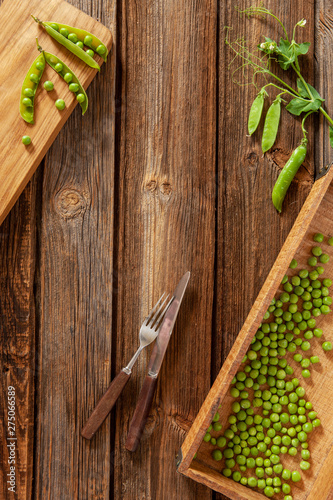 Green peas on wooden background. Top view, close-up