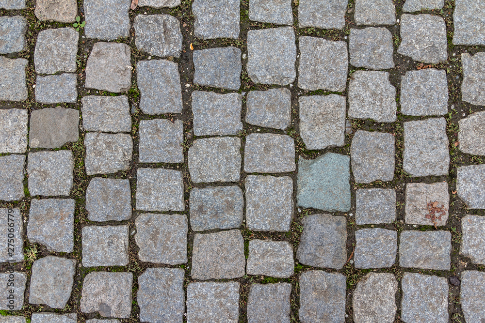 Old cobblestone tile texture in old town. City pavement background. Abstract granite stone brick pattern. Street sidewalk texture Old cobblestone tile texture in old town. City pavement background. Abstract granite stone brick pattern. Street sidewalk texture