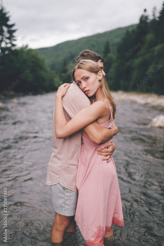 Lifestyle loving couple hugging in the river Lifestyle loving couple hugging in the river