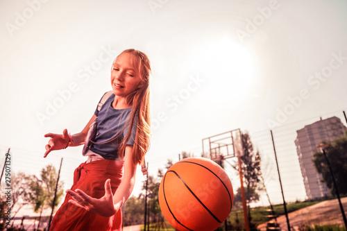 Tired young player improving her basketball technique