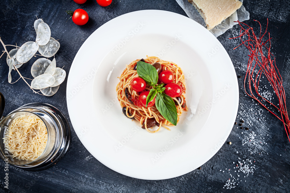 Close up view on traditional italian pasta with basil and cherry tomato in white plate. Flat lay italian cuisine with copy space for design. mediterranean noodle for lunch. Top view Close up view on traditional italian pasta with basil and cherry tomato in white plate. Flat lay italian cuisine with copy space for design. mediterranean noodle for lunch. Top view