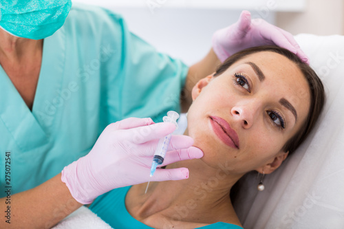 Woman during beauty facial injections