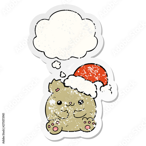 cute cartoon christmas bear and thought bubble as a distressed worn sticker