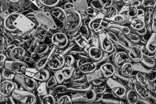 A close up of a box of stainless steel fasteners and clips, ideal for backgrounds