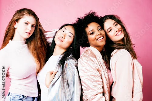 different nation girls with diversuty in skin, hair. Asian, scandinavian, african american cheerful emotional posing on pink background, woman day celebration, lifestyle people concept close up © iordani