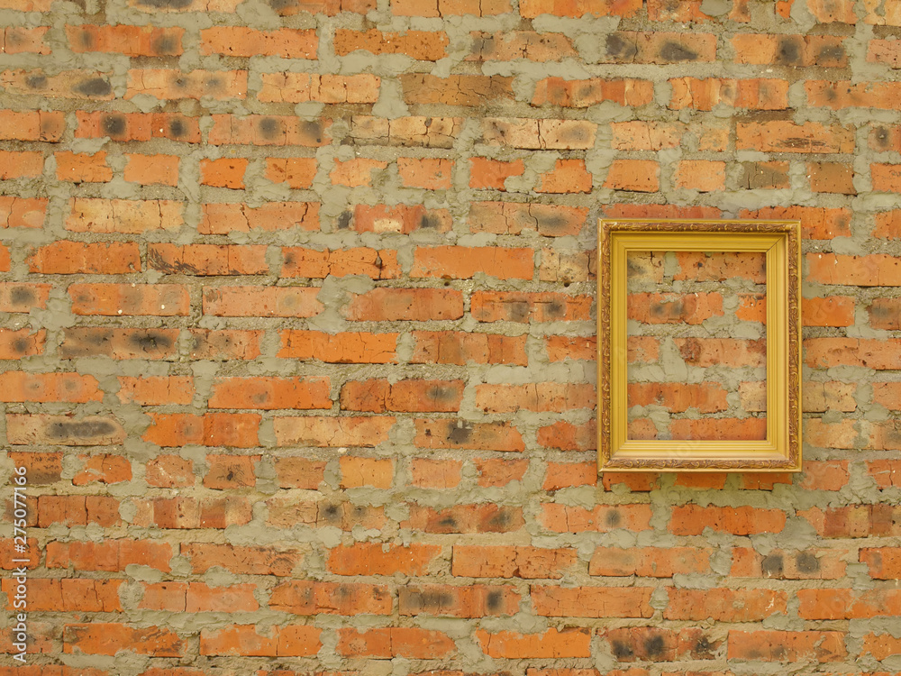 Fototapeta premium Picture frame from baguette on the background of an old brick wall