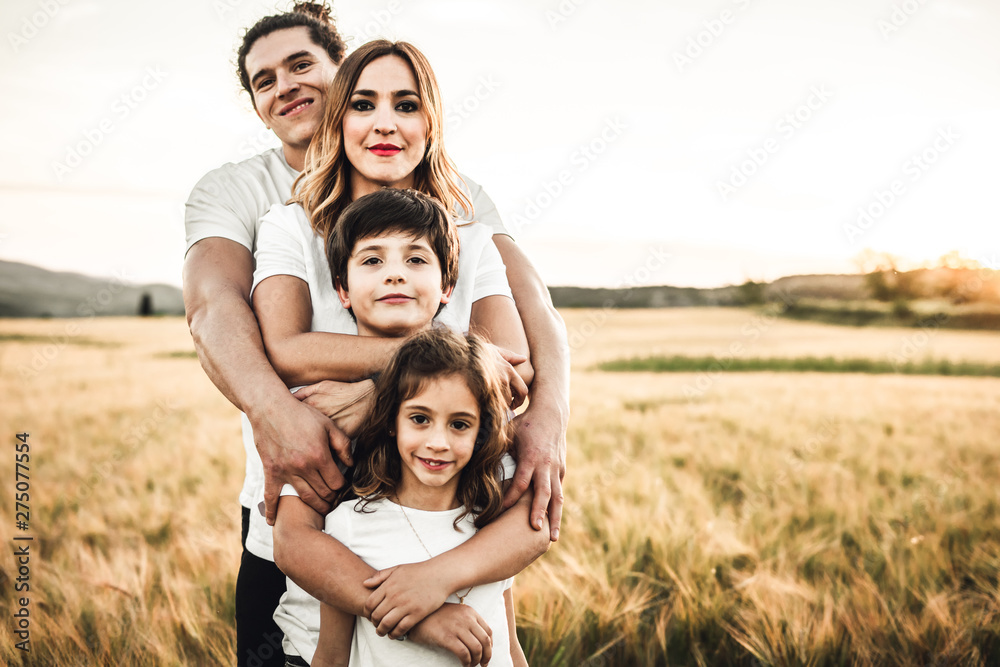 Portrait of a happy young family smiling in the countryside. Concept of family fun in nature. Portrait of a happy young family smiling in the countryside. Concept of family fun in nature.