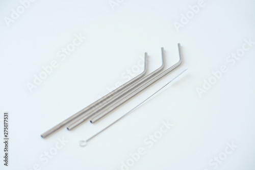 Lot of metal tubes for cocktails with schutkoy for cleaning isolated on white