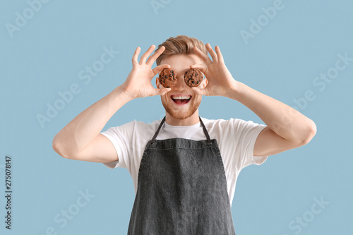 Happy male baker with tasty...