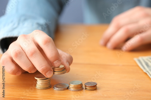 Woman counting money at table, closeup