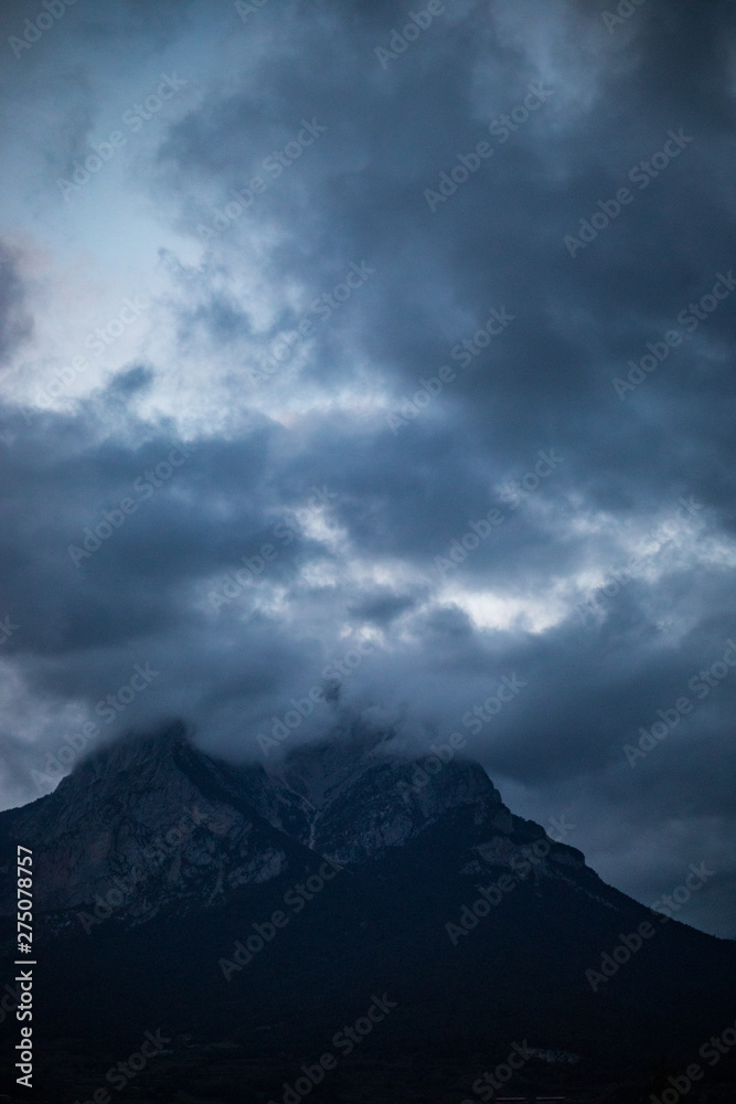 Mountain peak hidden by cloudy sky on evening at Pedra Forca