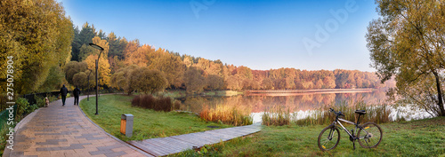 Moscow. October 15, 2018. Autumn landscape in the Meshchersky Park. People are walking their dogs along the picturesque paths around the pond early in the morning photo