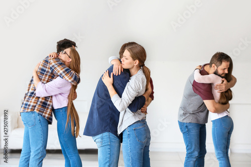 Hugging young people at group therapy session
