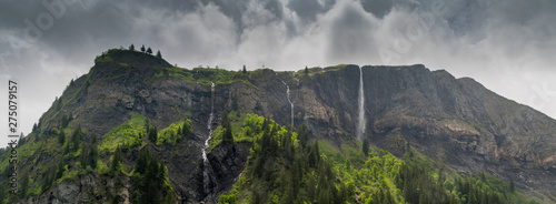 panorama mountain landscape with lush green forest and several waterfalls