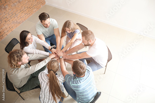 Young people putting hands ...