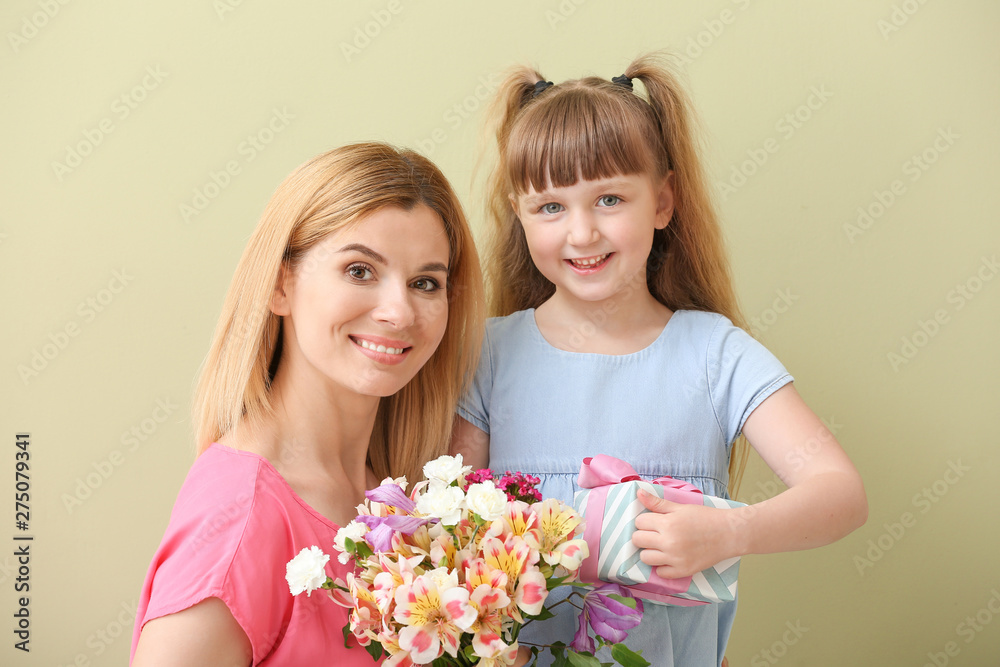 Little girl greeting her mother on color background Little girl greeting her mother on color background