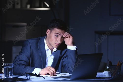 Tired businessman in office...