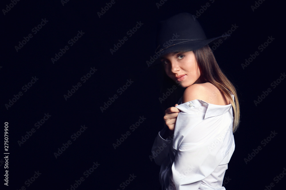 Fashionable young woman on dark background Fashionable young woman on dark background