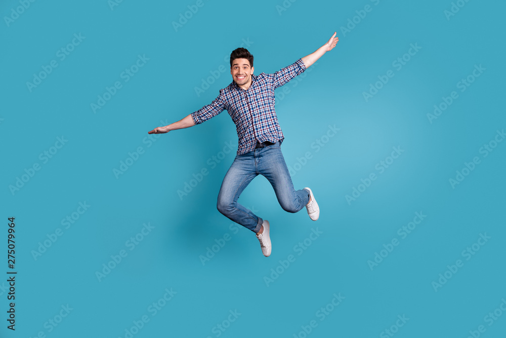 Full body length size photo of crazy humorous handsome carefree careless dreamy optimistic generation y millennial he him guy stretching arms hands to sides isolated pastel background