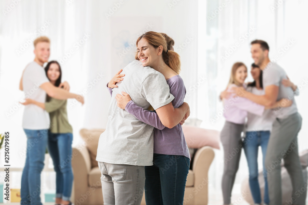 People hugging at group therapy session People hugging at group therapy session