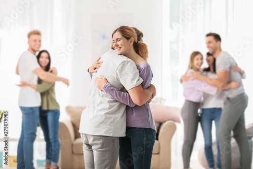 People hugging at group therapy session