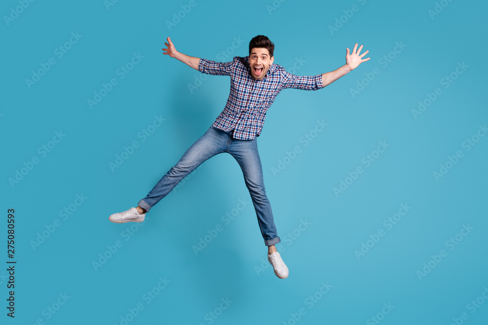 Full length body size view photo charming youngster fool careless shout summer spring holidays star open mouth reaction amazed surprised wow omg modern plaid outfit sneakers isolated blue background Full length body size view photo charming youngster fool careless shout summer spring holidays star open mouth reaction amazed surprised wow omg modern plaid outfit sneakers isolated blue background