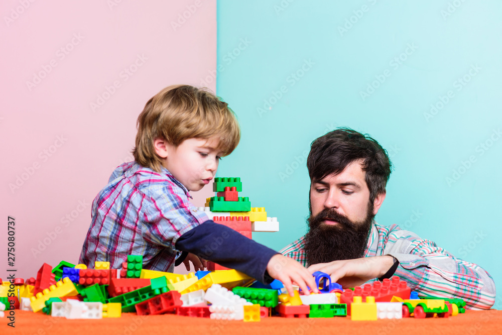 Fototapeta premium Happy family together. small boy with dad playing together. father and son play game. happy family leisure. child development. building home with color constructor kit. block kit. kit toy. toy shop