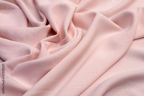 Fabric viscose (rayon). Color is light pink. Texture, background, pattern. photo