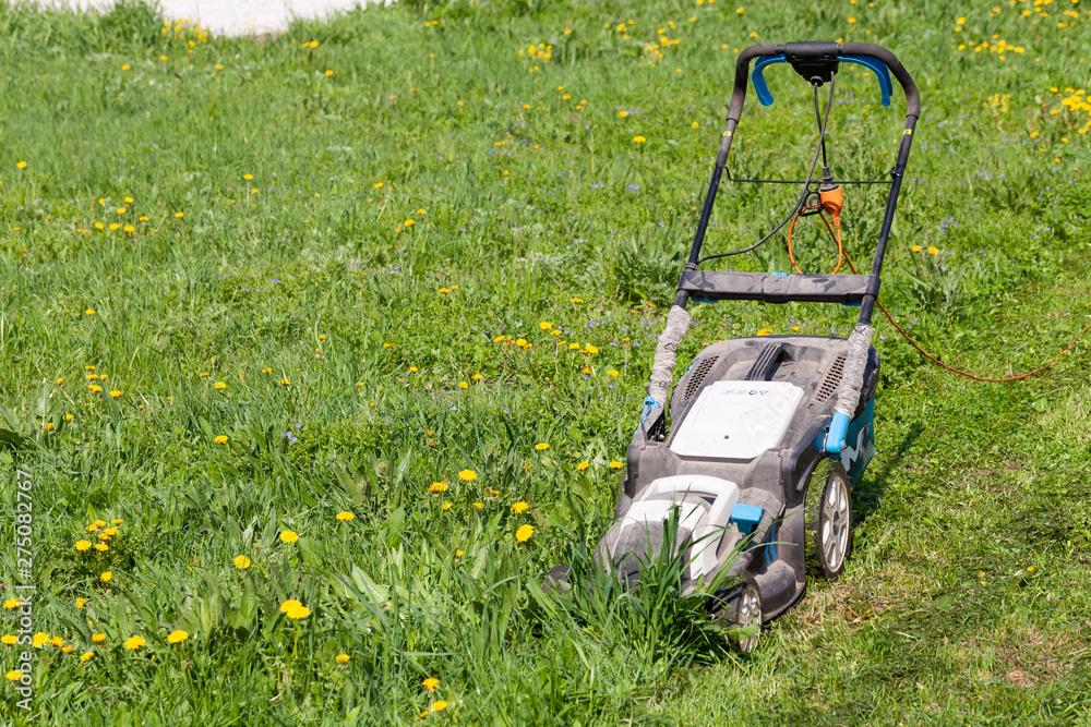 Lawn mower in the spring garden Lawn mower in the spring garden