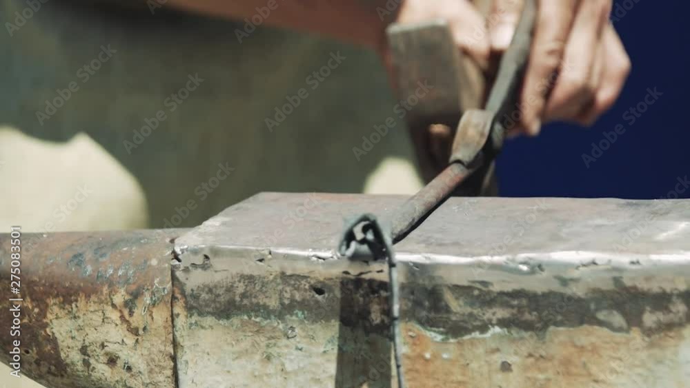 Blacksmith manufactures sheet metal plant. Hammer. Forge. Close-up. Hot metal. Iron. Slow motion. Blacksmith manufactures sheet metal plant. Hammer. Forge. Close-up. Hot metal. Iron. Slow motion.
