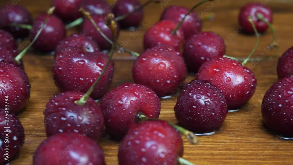 Fresh cherries with water drops on brown wooden background. Fresh and healthy fruit concept Fresh cherries with water drops on brown wooden background. Fresh and healthy fruit concept