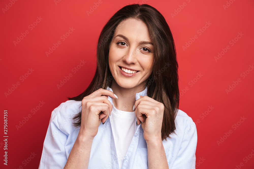 Happy young beautiful woman posing isolated over red wall background. Happy young beautiful woman posing isolated over red wall background.