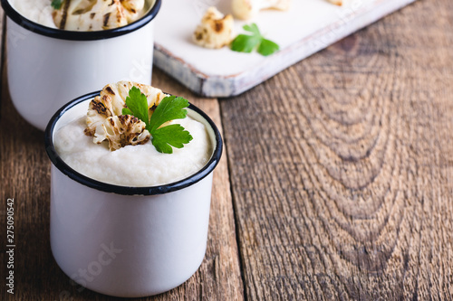 Healthy cauliflower cream soup in rural mugs