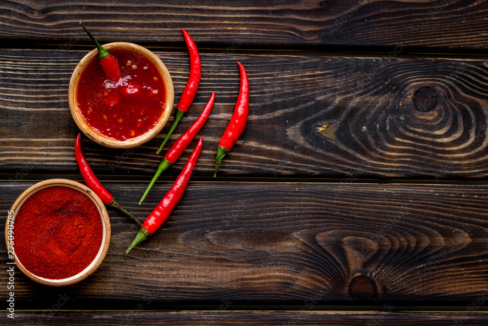 Fresh and powdered red hilli pepper pattern on wooden table background top view space for text Fresh and powdered red hilli pepper pattern on wooden table background top view space for text