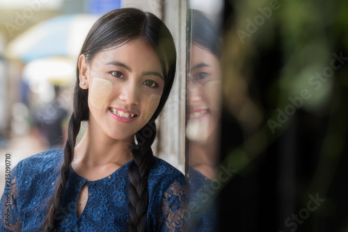 A beautiful  Myanmar woman, Yangon Myanmar,vintage style. Young Myanmar girls with Thanaka, a yellowish-white paste made from ground bark and used as a cosmetic and for sunburn protection.