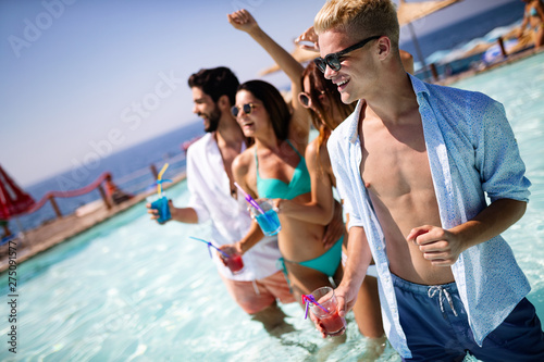 Group of happy friends having fun dancing at swimming pool outdoors © NDABCREATIVITY