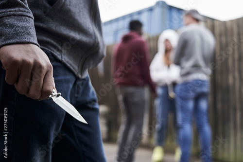 Fotografia, Obraz Close Up Of  Teenage Boy In Urban Gang Holding Knife